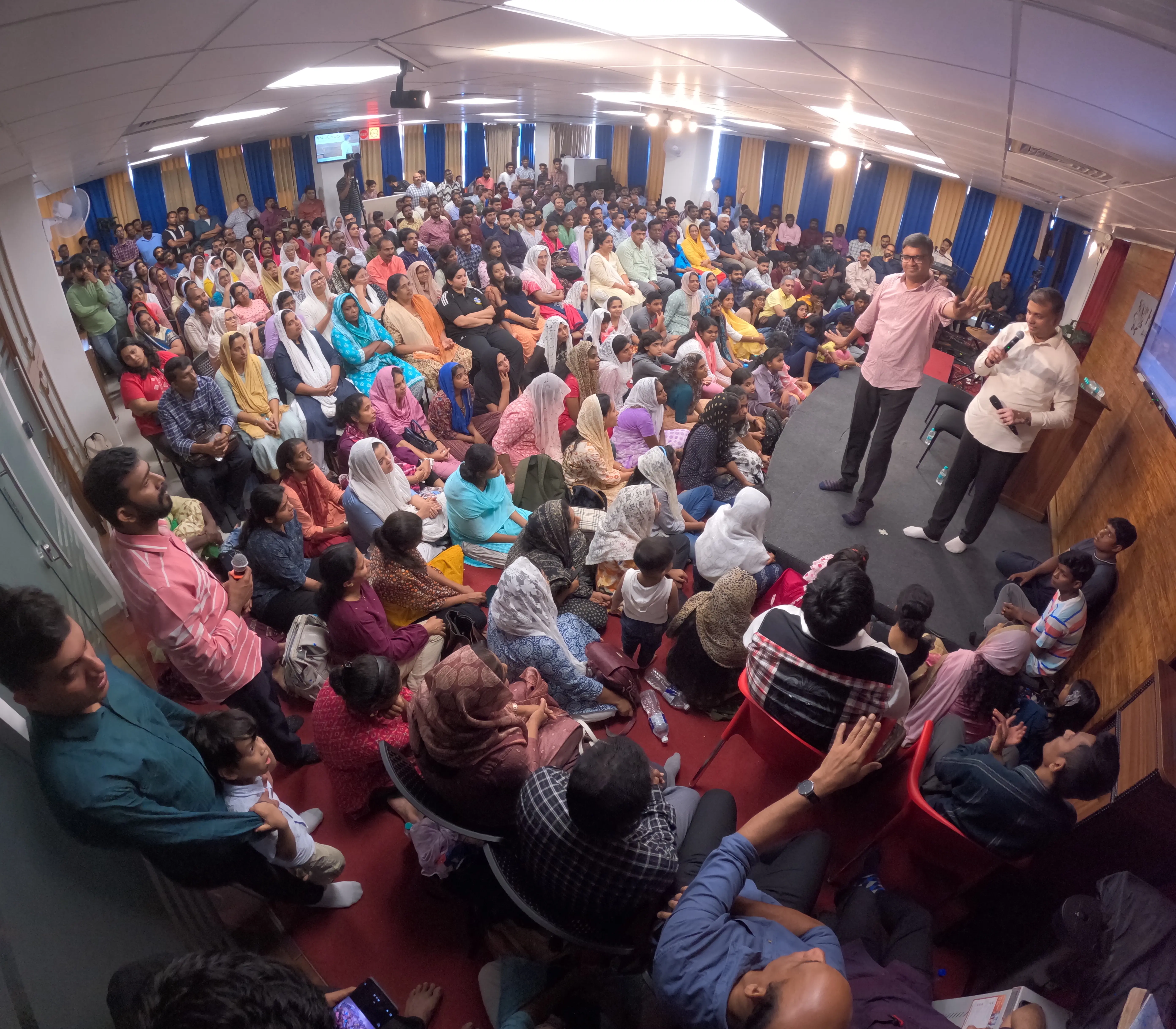 Packed church hall with families during revival